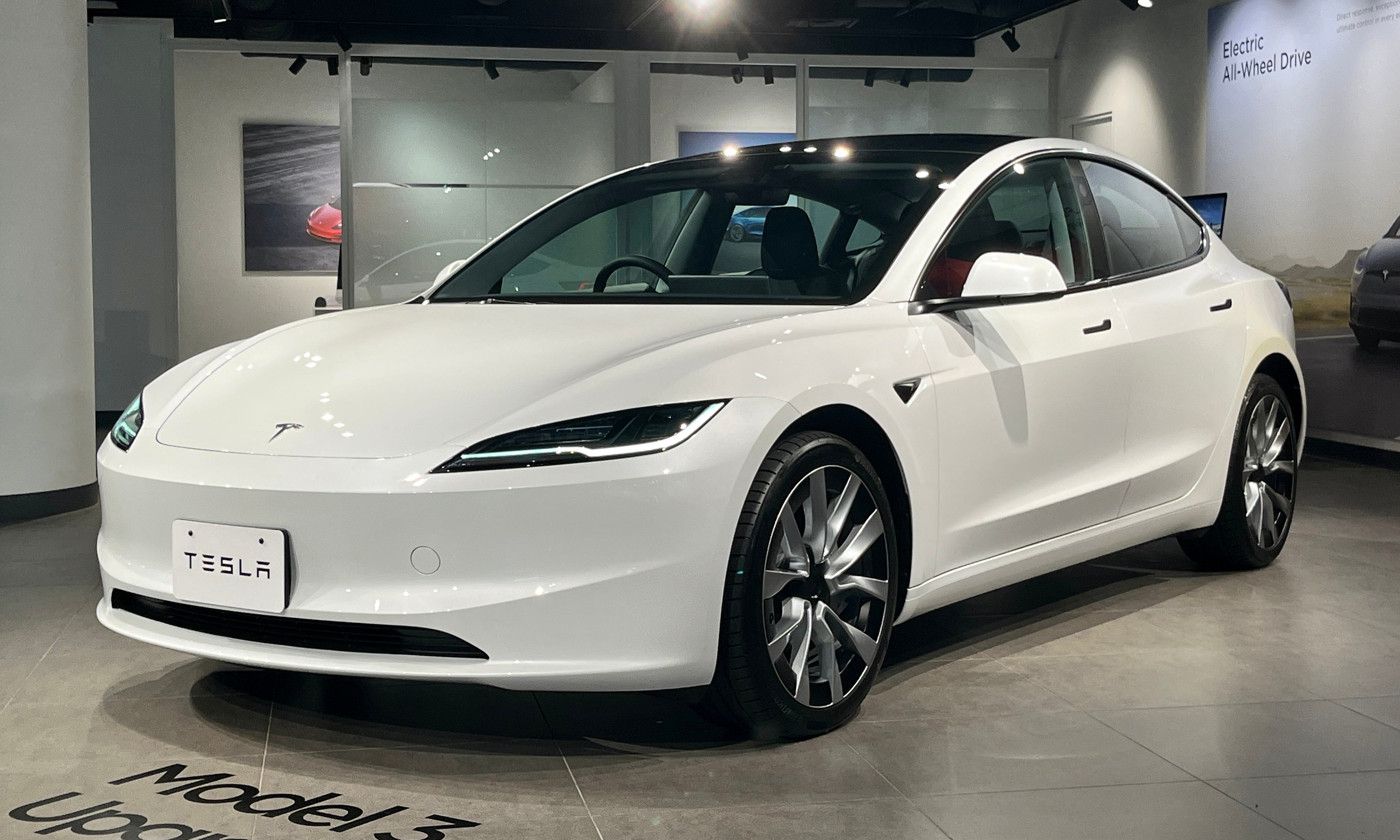 White refreshed Tesla Model 3 Long Range in a showroom